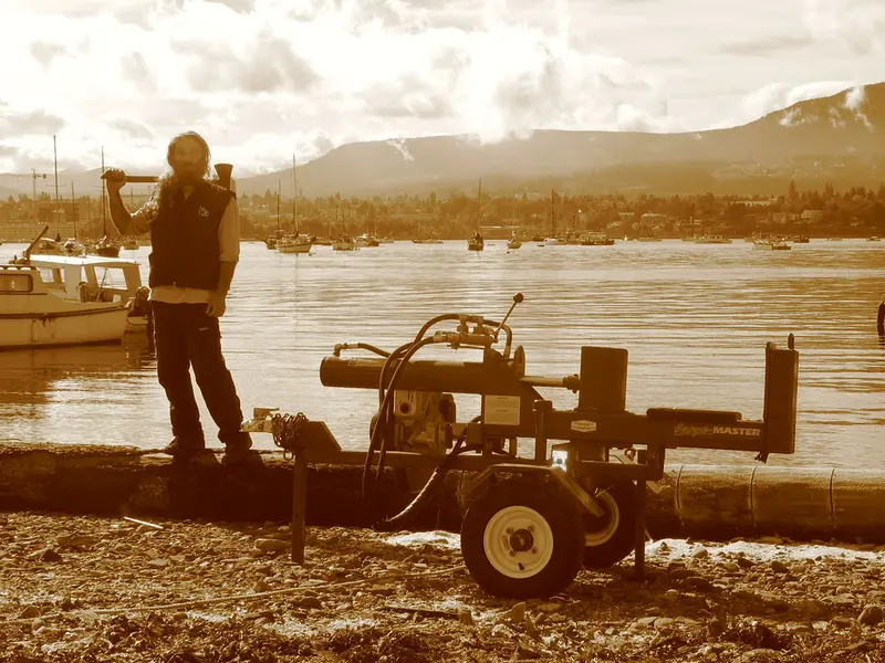 A horizontal log splitter with a round in the cradle