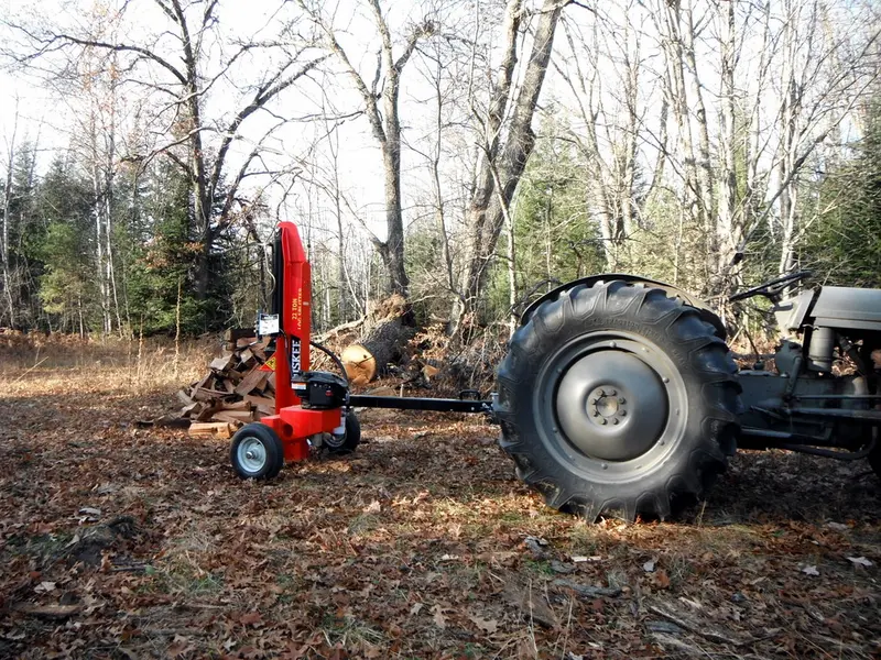A tractor-mounted log splitter set up for firewood work